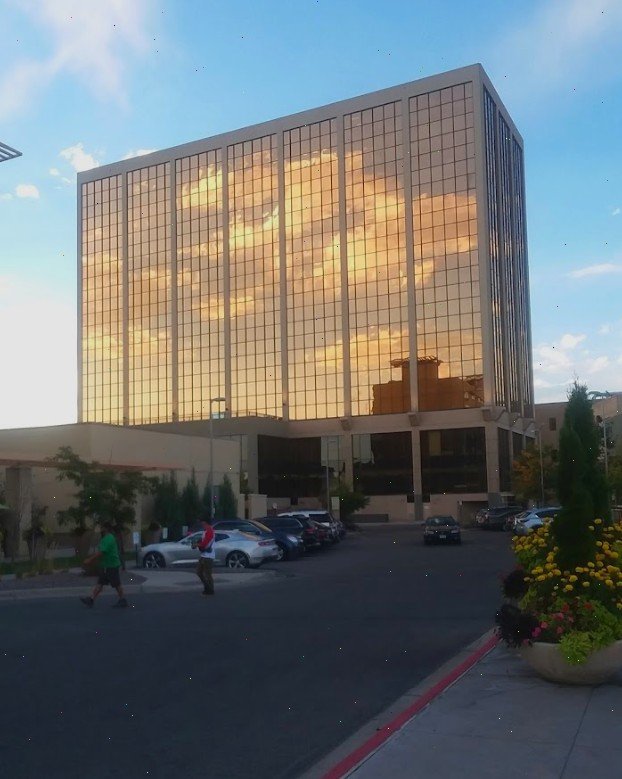 A building with two doors and windows on the side of it.